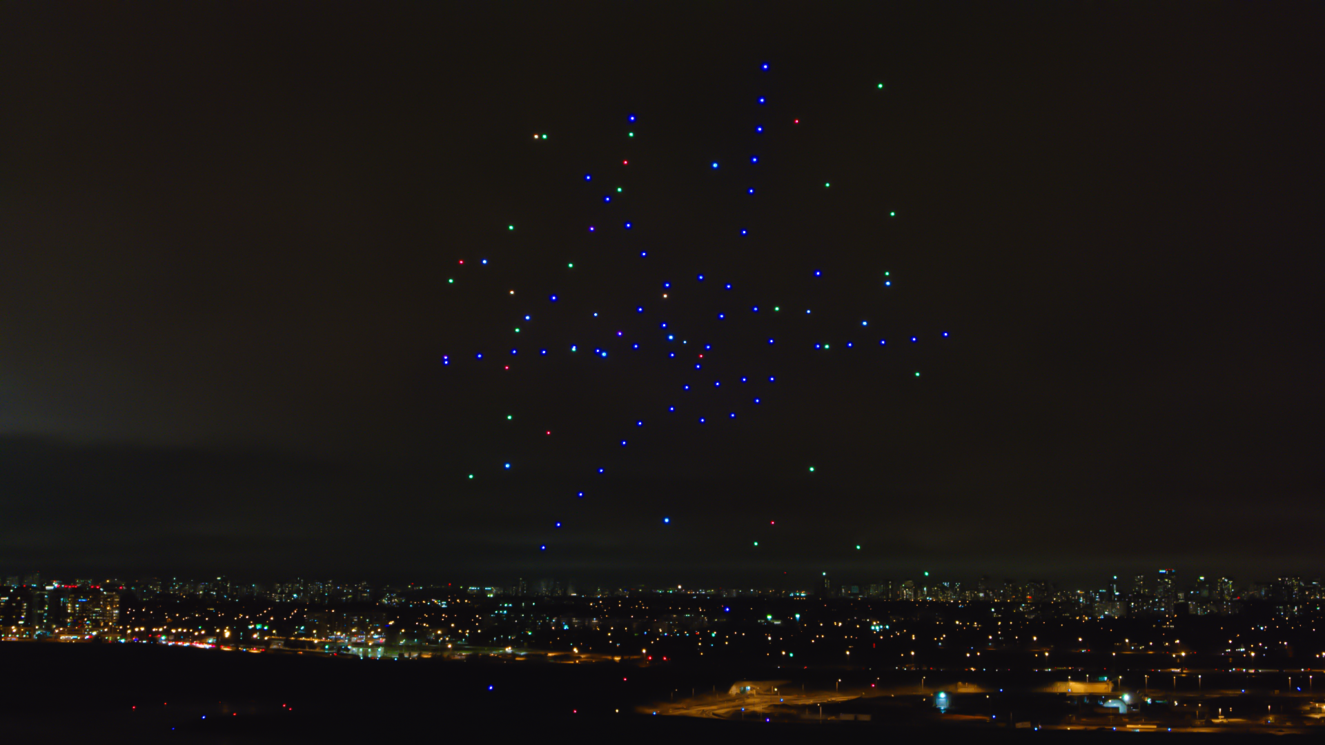 abstract image formed in an illuminated flying drone performance in the sky